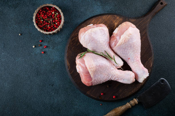 istock Raw uncooked chicken legs. meat with ingredients for cooking 1459168894