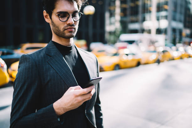 istock Confident hipster browsing mobile in street 1459168964