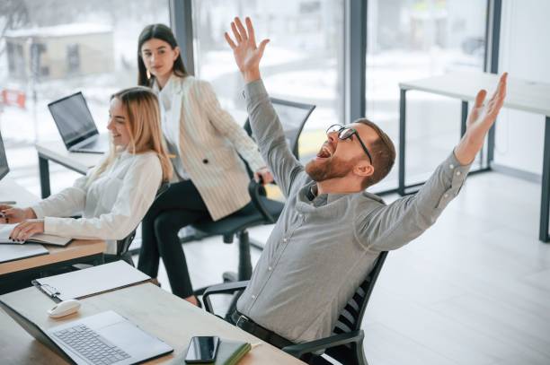 istock Man is satisfied about results. Successful team are working together in the office. Conception of business 1459169061