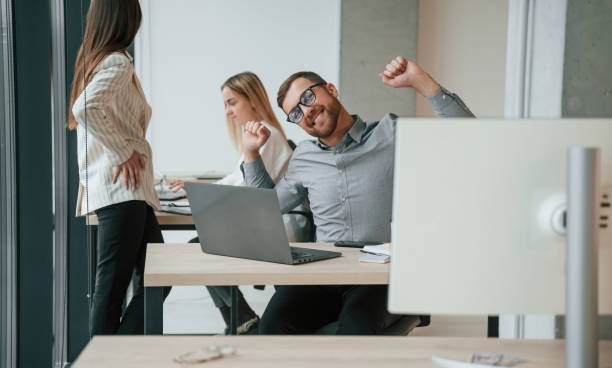 istock Silver colored laptop is on the table. Successful team are working together in the office. Conception of business 1459169246