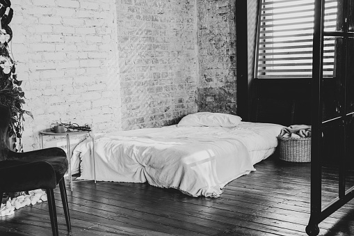 mattress on the floor near the window, bed in the bedroom, bedroom interior in the apartment, stylish bedroom