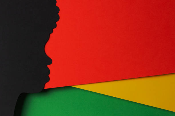 istock Black History Month color background. African Americans history celebration. Abstract geometric red, yellow, green color background with black paper cut people silhouette. Top view 1459169984
