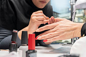 The manicurist is making new nails. Manicure. Beauty treatment and hand care