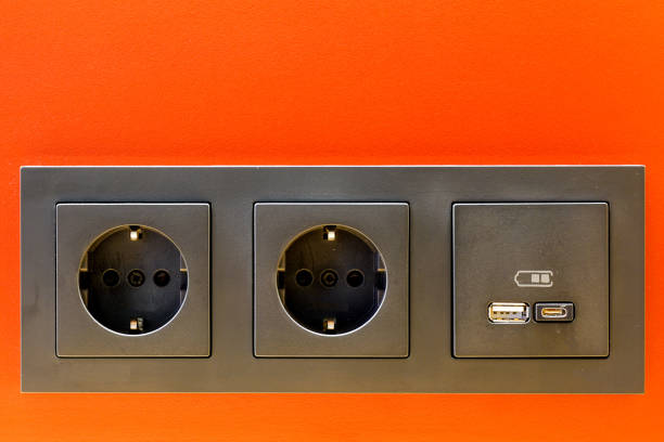 istock A black 220V, USB and USB C socket block is built into the orange wall surface 1459173270