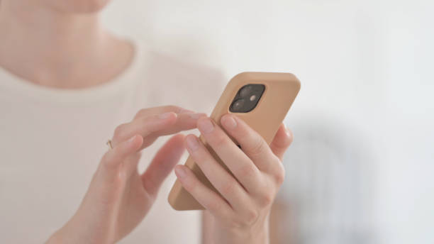 istock Close up of Female Hand Using Smartphone, Browsing Internet and Messaging 1459175064
