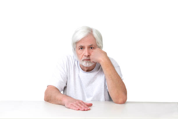 istock Bored White-Haired Man Sitting With Fist On Cheek Isolated 1459175734