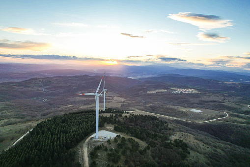 solar panels and wind turbines at sunset. renewable energy sources