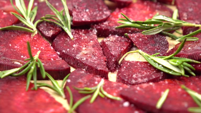 Sprigs   of rosemary and slices of beets, natural background.