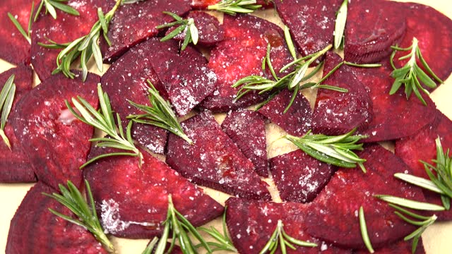 Sprigs   of rosemary and slices of beets, natural background.