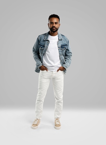 Handsome young african american guy posing in studio - isolated.