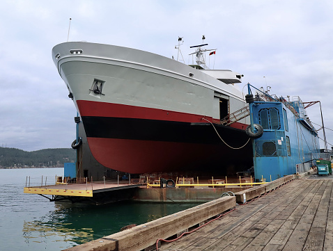 A large ferry boat in dry dock for yearly maintenance