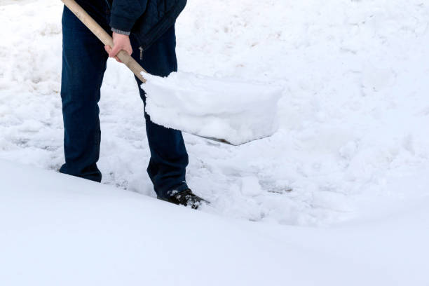 istock A man cleans snow with a metal shovel 1459179133