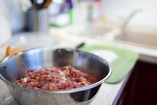 Cooking food. Minced meat in a metal bowl, close-up.