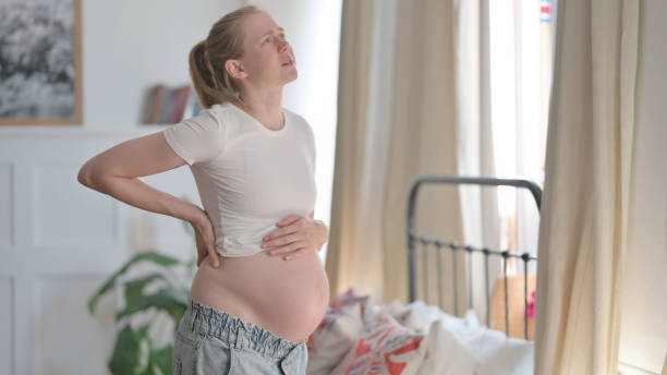 istock Standing Pregnant Woman having Back Pain 1459183661