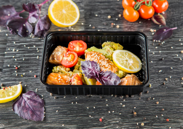 istock A dish in a black disposable container from catering on a concrete background, dietary catering, ready meals with you, healthy food 1459184954