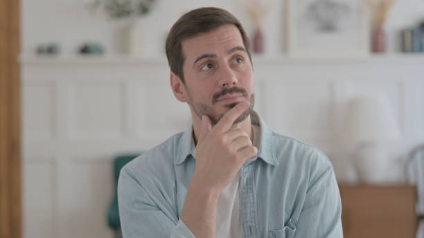 istock Portrait of Thinking Young Man Getting New Idea 1459185219