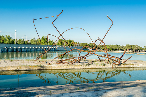 Madrid, Spain - May  4, 2021: The work Walk between two trees (Paseo entre dos arboles), an abstract sculpture by the artist Jorge Castillo, made in 1994, exhibited in the modern Juan Carlos I Park in Madrid, Spain