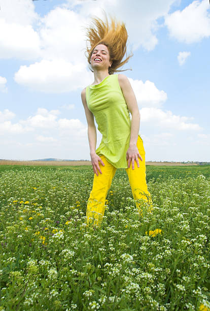 istock Young woman standing on a green field, spring time 145918749