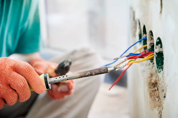 istock Male electrician hands using electric soldering iron. 1459188266