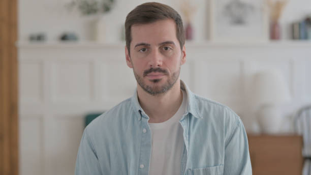 istock Portrait of Serious Young Man Looking at the Camera 1459189882