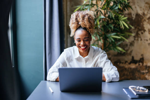 istock Cheerful Smiling Businesswoman Using A Laptop Computer In The Cafe 1459190361