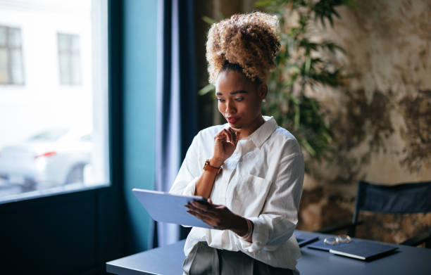 istock Happy Businesswoman Using A Digital Tablet In Her Office 1459190384