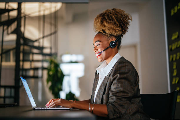 istock Smiling Businesswoman Talking With Customer While Using A Laptop Computer In The Office 1459191052