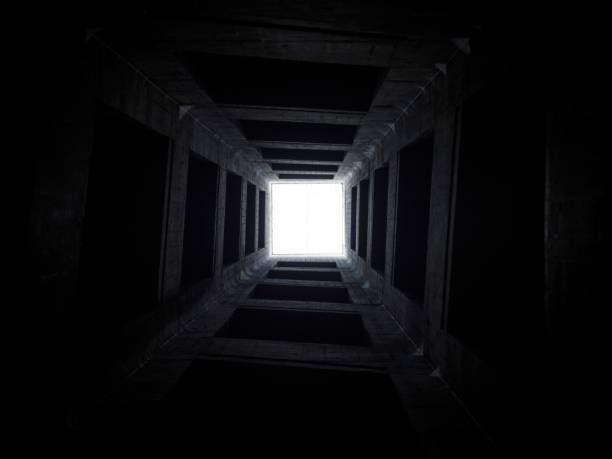 istock Looking up to sky inside interior indoor tower well shaft stone structure architecture light at the end of the tunnel 1459191864