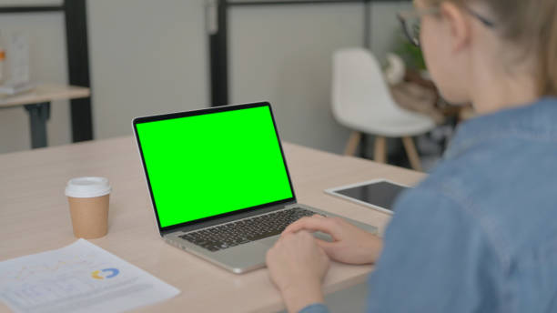 istock Young Woman Using Laptop with Green Screen 1459195977