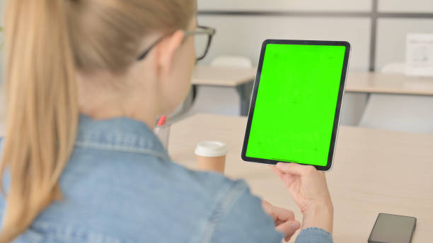 istock Rear View of Young Woman using Tablet with Chroma Key 1459196658