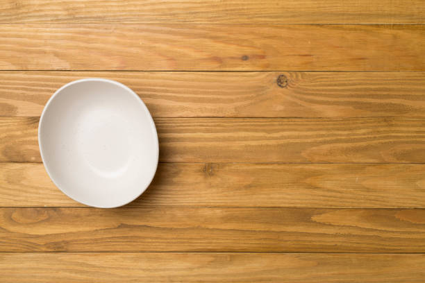 istock Empty round plate on wooden background, top view 1459197590