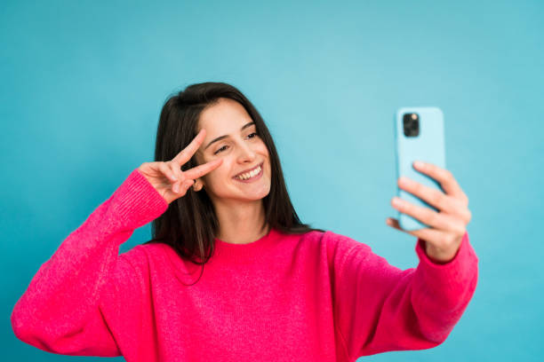 istock Cheerful woman taking selfie on smartphone 1459198547