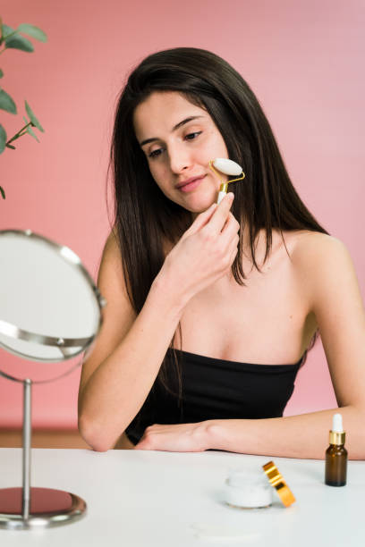 istock Young woman applying roll on at her face 1459199218