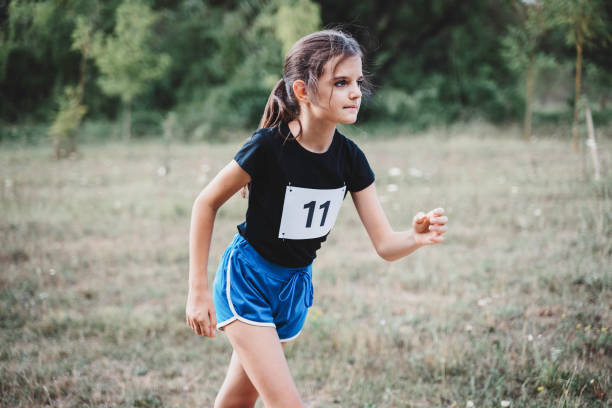 istock Cute girl preparing for run on the running track. 1459199349