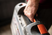 Close-up of a senior man holding a tool box