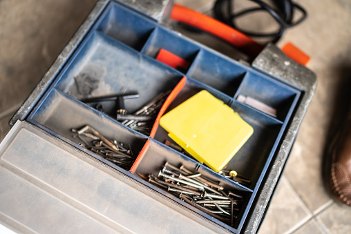 Close-up of a tool box with nails and screws at home