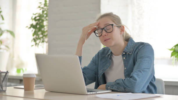 istock Frustrated Young Woman Angry while Using Laptop 1459201125
