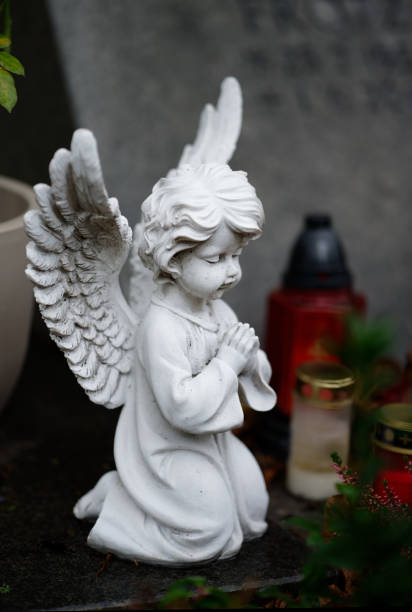 istock praying angel figure on a grave 1459204389