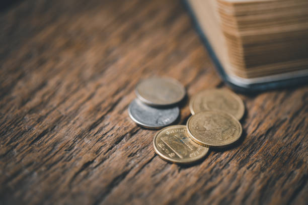 One tenth or tithe is basis on which Bible teaches us to give one tenth of first fruit to God. coins with Holy Bible. Biblical concept of Christian offering, generosity, and giving tithes in church.