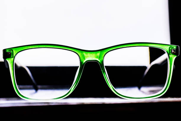 Glasses for vision correction in a green frame. Glasses in front of the window.