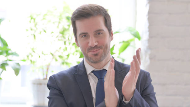 istock Young Businessman Clapping in Appreciation in Office 1459206036