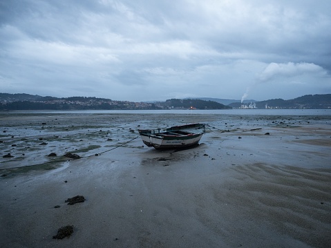 Stranded fishing boat vessle ship on shore of seaside traditional historical old fishing town village Combarro Poyo Pontevedra Poio Galicia Spain Europe at low tide
