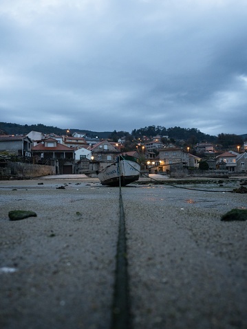 Stranded fishing boat vessle ship on shore of seaside traditional historical old fishing town village Combarro Poyo Pontevedra Poio Galicia Spain Europe at low tide