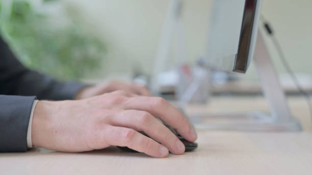 istock Side View of Businessman Using Mouse and Typing on Desktop Keyboard 1459206925