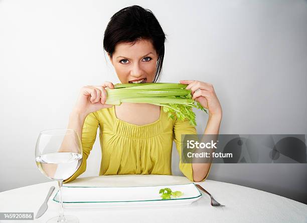 Young Woman Having Her Breakfast With Water And Celery Stock Photo - Download Image Now