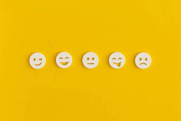 emoticon smile on a yellow background. customer feedback. - rating ranking quality control aspirations imagens e fotografias de stock