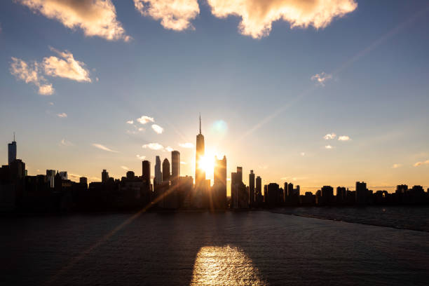 beautiful downtown chicago skyline aerial over lake michigan during the chicago henge or autumn equinox as the golden colored sun aligns with the streets between high-rise buildings. - lake michigan sun sunlight nature imagens e fotografias de stock