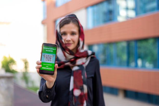istock A Muslim woman shows her vaccination passport. 1459213530