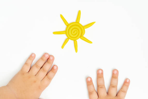 istock Little toddler plays play dough. Modeling yellow sun. 1459215085