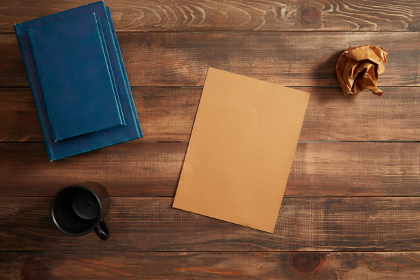 Notepad, crumpled paper and cup of coffee
